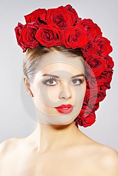 Portrait of smiling girl with red roses hairstyle