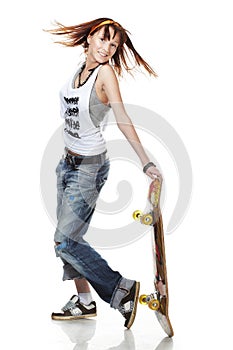 Portrait of smiling girl standing with skateboard