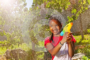 Portrait of smiling girl in water fight game