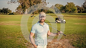 portrait of smiling golfer in cap with golf club, summer
