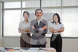 Portrait of smiling group Asian professional confident business people team standing and looking at camera