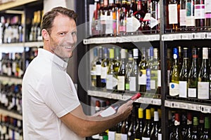 Portrait of a smiling handsome having a wine bottle in her hands