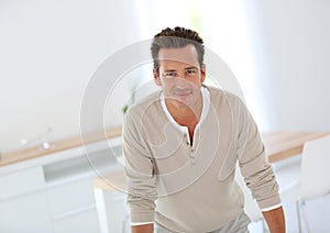 Portrait of smiling handsome man at home