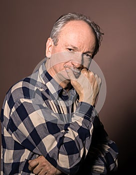 Portrait of smiling handsome senior man looking at the camera o