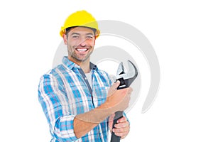 Portrait of smiling handyman holding adjustable spanner