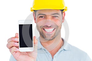 Portrait of smiling handyman showing smart phone