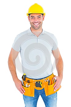 Portrait of smiling handyman wearing tool belt