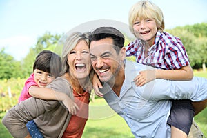 Portrait of smiling happy family in countryside