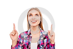 Portrait of smiling happy girl pointing up with fingers