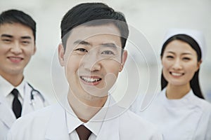 Portrait of Smiling Healthcare workers in China, Two Doctors and Nurse in Hospital, Looking At Camera