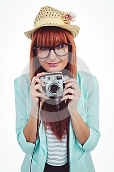 Portrait of a smiling hipster woman holding retro camera