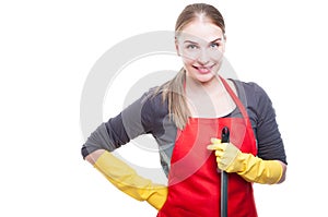 Portrait of smiling housekeeper holding mop photo
