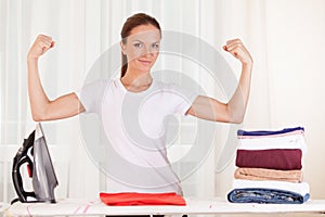 Portrait of smiling housewife ironing clothes.