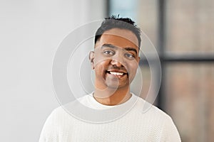 Portrait of smiling indian businessman at office