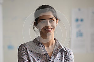 Portrait of smiling indian female employee posing for photo