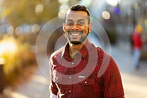 Portrait of a smiling Indian man looking at the camera