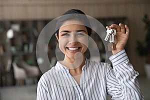 Portrait of smiling Indian woman show keys to new home