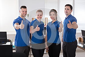 Janitors Showing Thumb Up Sign In The Office