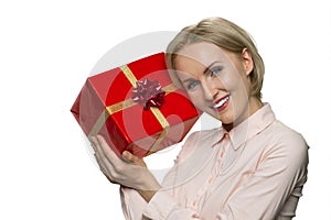 Portrait of smiling joyful woman with celebratory gift box.