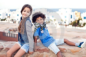 A portrait of smiling kid boy and girl outdoor. Children and emotions concept