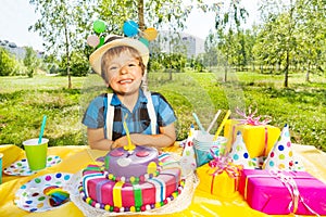 Portrait of smiling kid boy making a birthday wish