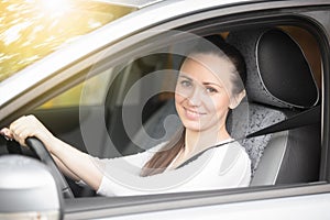 Portrait of smiling lady driver showing thumb up