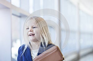Portrait of smiling little blond girl wearing blue jacket
