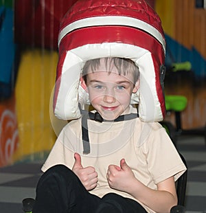 Portrait of a smiling little boy with a funny hat on his head