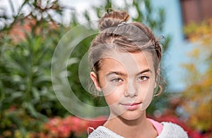 Portrait of a smiling little girl with autumn leaves background