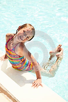 Portrait of smiling little girl swimming in pool