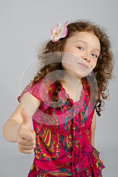 Portrait of smiling little girl with thumb up