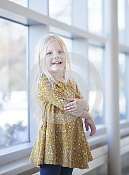 Portrait of smiling little girl wearing yellow frock