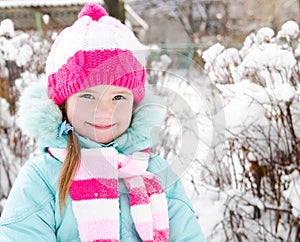 Portrait of smiling little girl in winter day