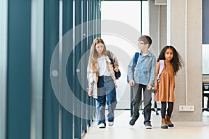 Portrait of smiling little school kids in school corridor