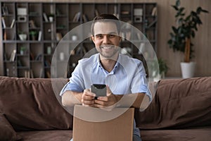 Portrait of smiling male buyer track order on cell