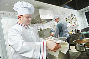 Portrait of a smiling male chef standing in the kitchen