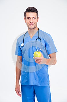 Portrait of a smiling male doctor holding apple i