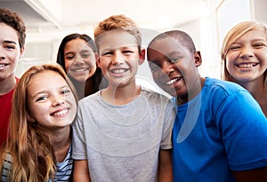 Portrait Of Smiling Male And Female Students In Grade School Classroom photo