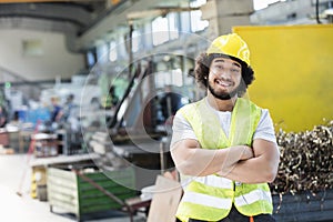 Portrait of smiling male manual worker standing arms crossed in metal industry