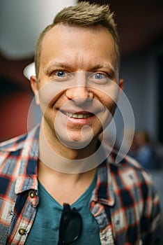 Portrait of smiling male spectator in cinema hall