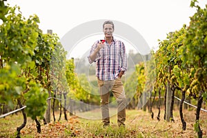 Portrait of smiling male vintner holding a glass of wine