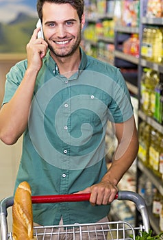 Portrait of smiling man buy food and phoning