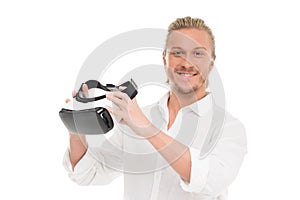 portrait of smiling man holding virtual reality headset in hands