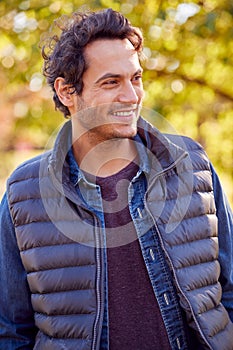 Portrait Of Smiling Man Outdoors Relaxing In Autumn Park