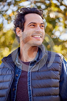 Portrait Of Smiling Man Outdoors Relaxing In Autumn Park