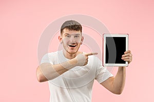 Portrait of smiling man pointing at laptop with blank screen isolated on white