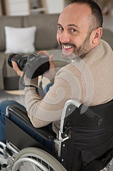 portrait smiling man using mirrorless camera