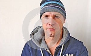 Portrait of the smiling man wearing a knitted hat