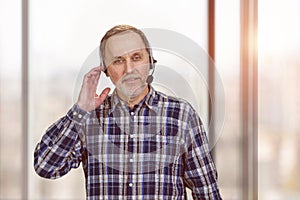 Portrait of smiling mature business man with headset.