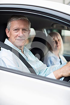 Portrait Of Smiling Mature Couple On Car Journey Together